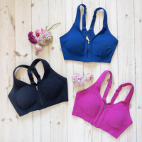 A blue, a pink, and a black compression sports bra